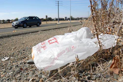 A plastic shopping bag liters the roadside in Sacramento, Calif, Friday, Oct. 25, 2013.