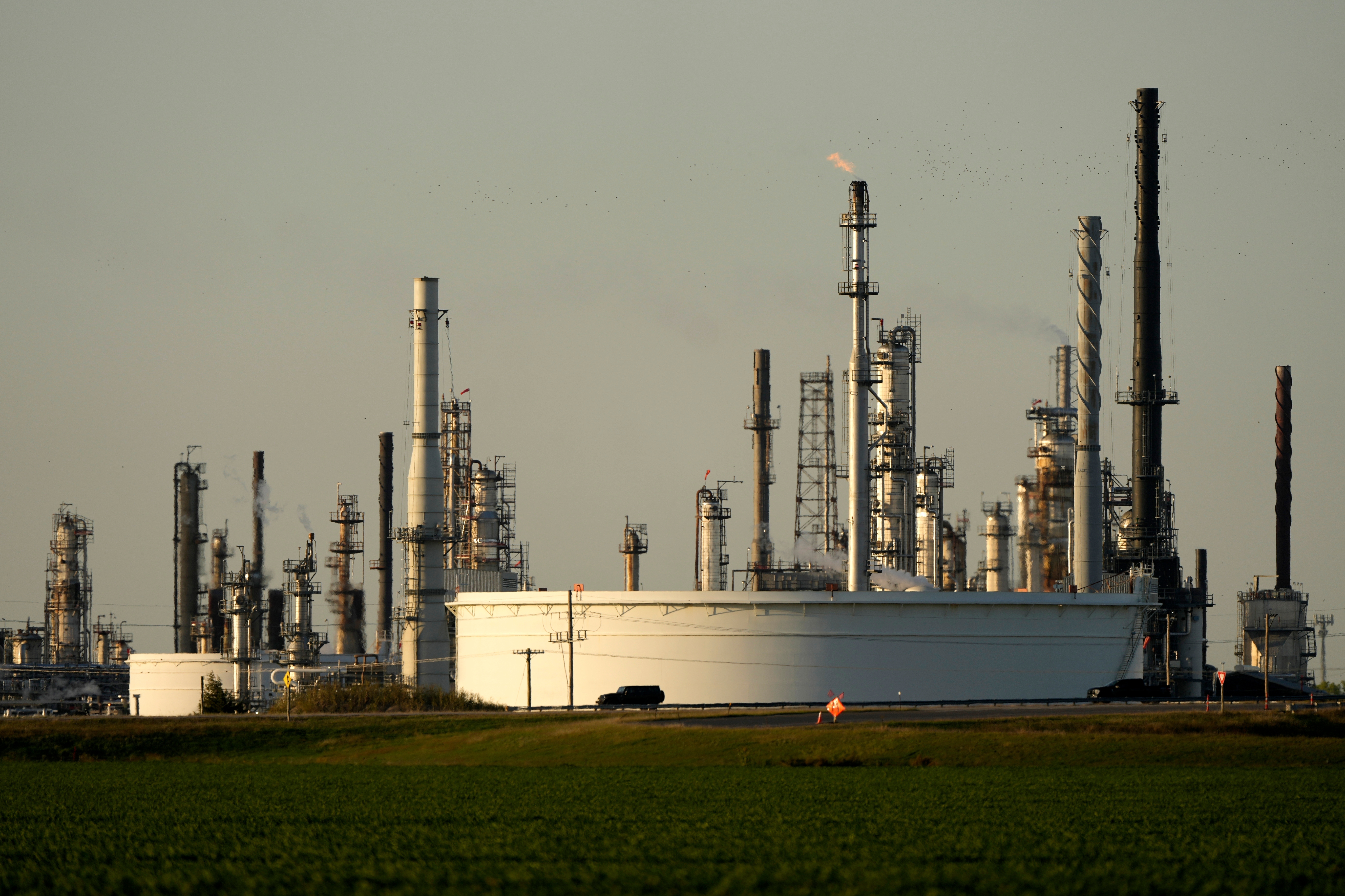 A motorist drives past the CHS oil refinery Sept. 28, 2024, in McPherson, Kan.