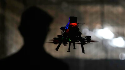 Colin Balfour, a sophomore studying robotics engineering, flies a small drone at a simulated night flight at a laboratory at the Worcester Polytechnic Institute, Monday, Oct. 20, 2025, in Worcester, Mass.