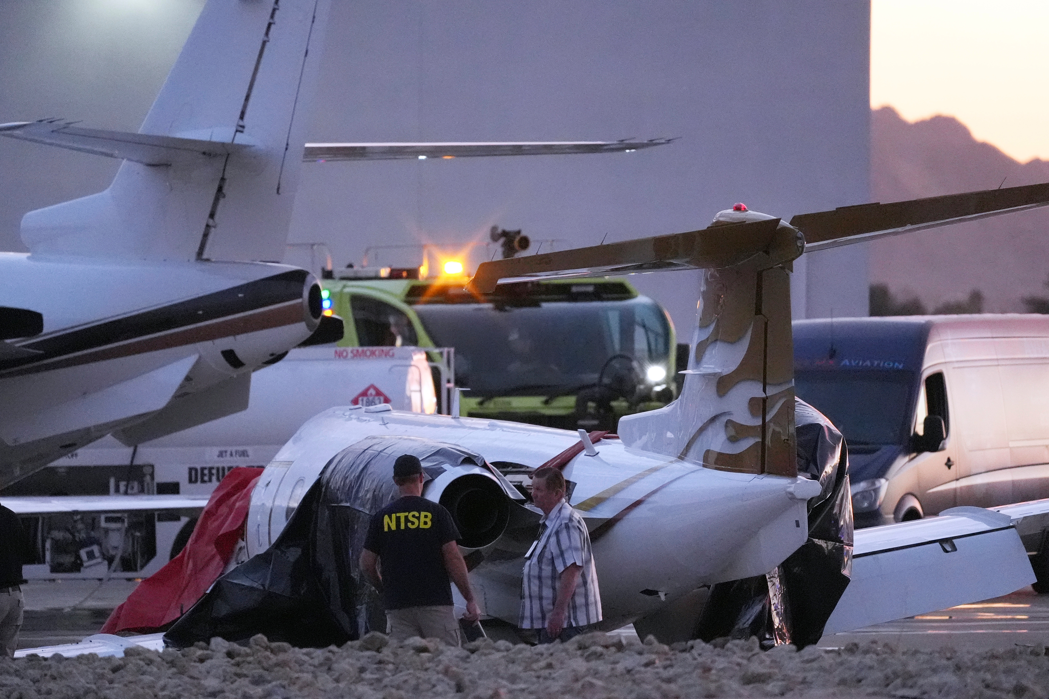Investigators look at a crashed Learjet at Scottsdale Airport after it collided with a parked plane Feb. 10, 2025, in Scottsdale, Ariz.