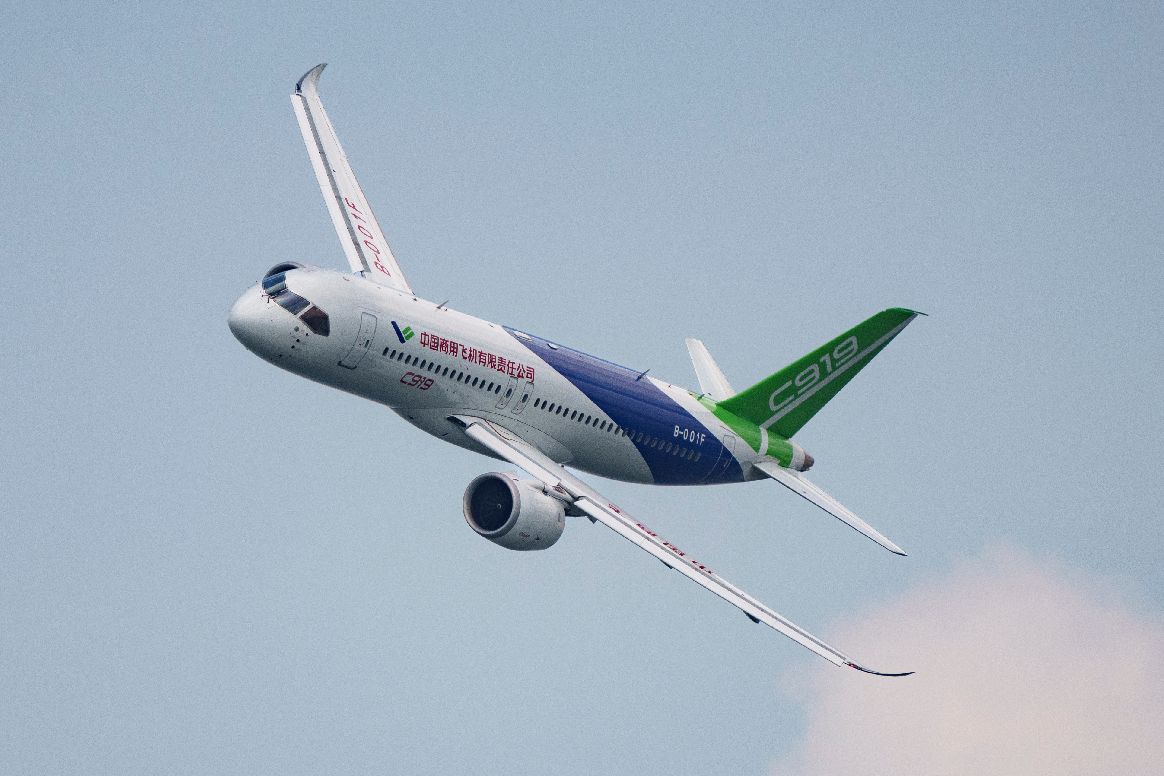 Attendees pass by a model of the Chinese-made C919 passenger jet at the Sinochem booth during the China International Supply Chain Expo in Beijing, Nov. 27, 2024.