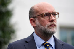 Russell Vought, Office of Management and Budget director, listens as he addresses members of the media outside the West Wing at the White House in Washington, Monday, Sept. 29, 2025, in Washington.