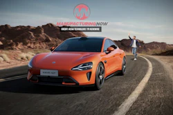 Orange Xiaomi electric sports car on a winding mountain road with rocky landscape