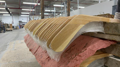 Wooden hockey sticks are stacked as they move along the assembly line at the Roustan Hockey factory, which is the last major manufacturer of hockey sticks in Canada on Aug. 27, 2025 in Brantford, Ontario.