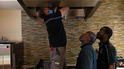 Maintenance workers Enaytullah Hafizi, left, originally from Afghanistan, Eric Frimpong, center, originally from Ghana, and Melvin Palmer, right, originally from Sierra Leone, fix an overhead light at Goodwin House Alexandria, Thursday, Oct. 16, 2025, in Alexandria, Va.