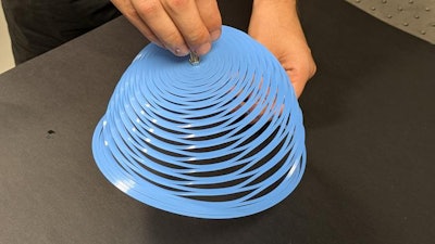 Laser cutting of a closed-loop kirigami pattern allows a plastic sheet to adopt the shape of an inverted bell.