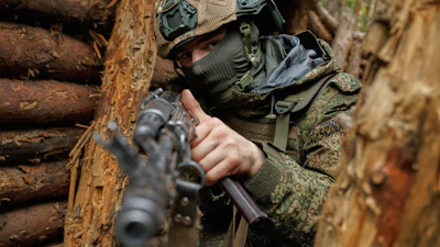 In this photo taken and distributed by Russian Defense Ministry Press Service on Monday, Oct. 6, 2025, a Russian soldier attends a combat training at one of the training grounds of the Moscow Military District.