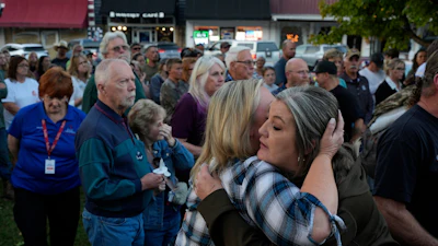Christina Williams, right, hugs Tracy Cook during a candlelight vigil honoring the victims of a blast at an explosives plant, Accurate Energetic Systems, Sunday, Oct. 12, 2025, in Waverly, Tenn.
