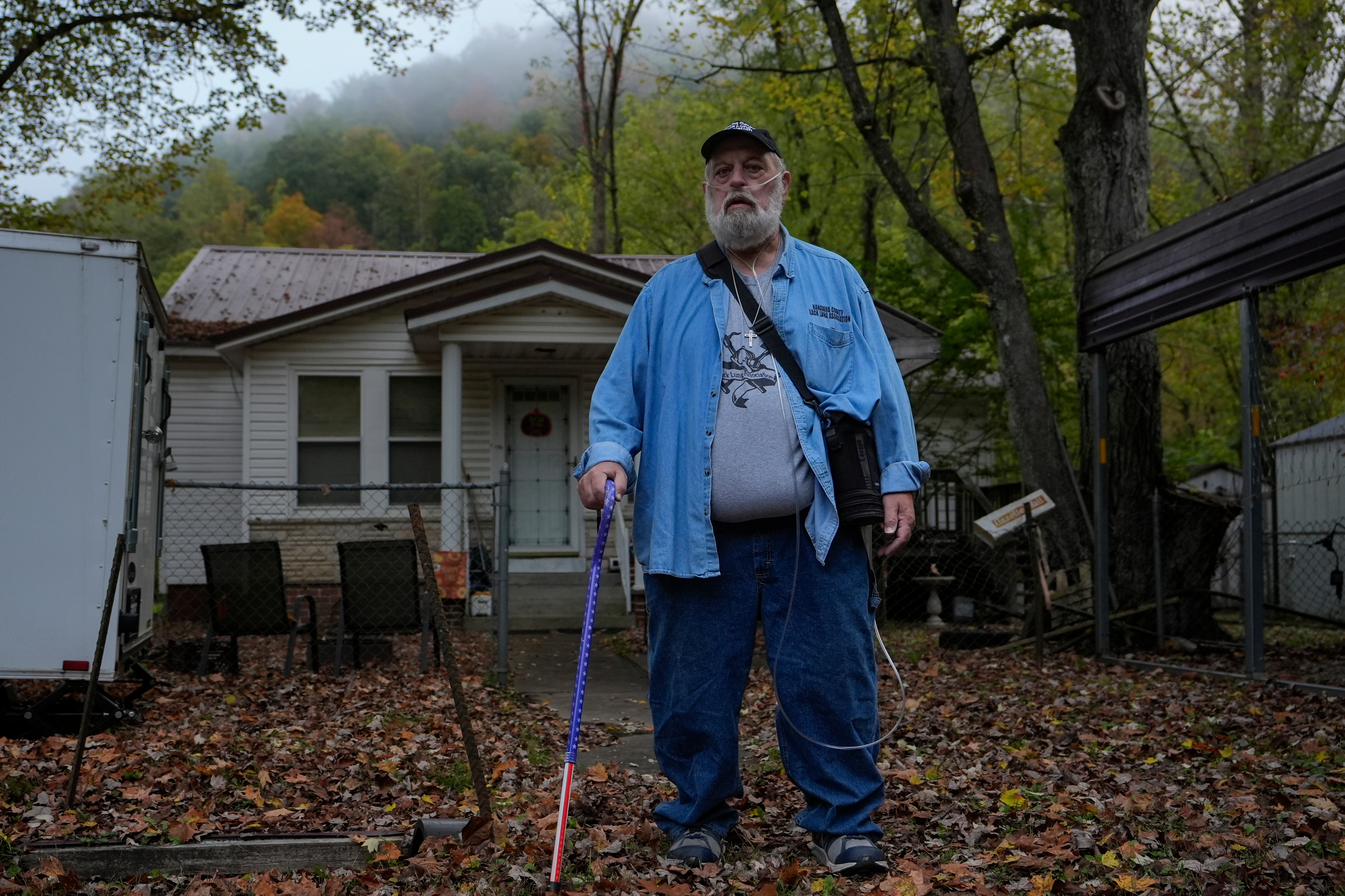 Randy Lawrence, president of the Kanawha County Black Lung Association, stands outside his home wearing supplemental oxygen for black lung disease near Cabin Creek, W.Va., Oct. 13, 2025.
