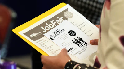 A job seeker waits to talk to a recruiter at a job fair, Aug. 28, 2025, Sunrise, Fla.