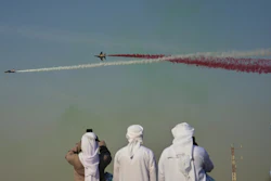 Emirati men take photos of Fursan Al Emarat, the aerobatics demonstration team of the United Arab Emirates Air Force during the Dubai Air Show in Dubai, United Arab Emirates, Tuesday, Nov. 18, 2025.