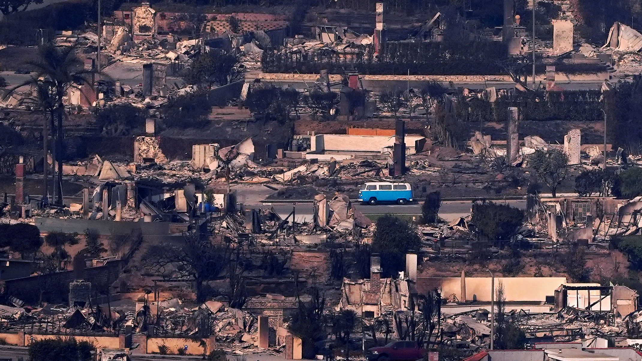 A VW bus sits among burned out homes, Thursday, Jan. 9, 2025, in Malibu, Calif.