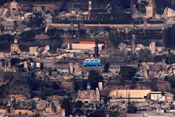 A VW bus sits among burned out homes, Thursday, Jan. 9, 2025, in Malibu, Calif.