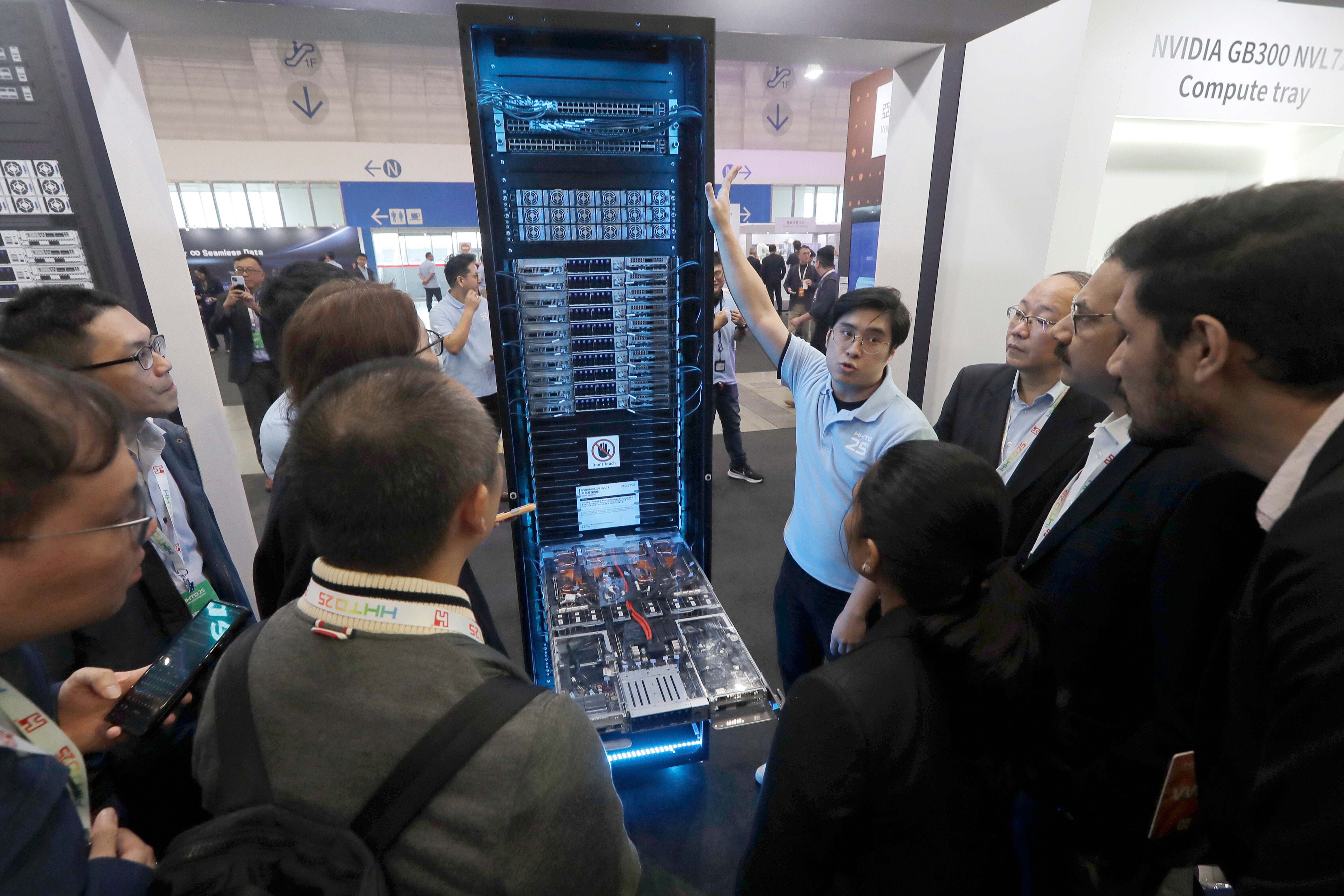 Visitors listen to the introduction of NVIDIA GB300 NVL72 AI server during the Hon Hai Tech Day (HHTD 25) at the Nangang Exhibition Center in Taipei, Taiwan, Friday, Nov. 21, 2025.