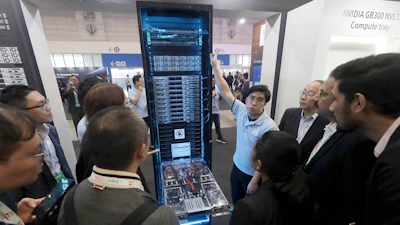 Visitors listen to the introduction of NVIDIA GB300 NVL72 AI server during the Hon Hai Tech Day (HHTD 25) at the Nangang Exhibition Center in Taipei, Taiwan, Friday, Nov. 21, 2025.