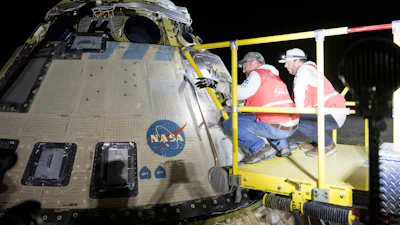 In this photo provided by NASA, Boeing and NASA teams work around NASA's Boeing Crew Flight Test Starliner spacecraft after it landed uncrewed, Sept. 6, 2024, at White Sands, New Mexico, after undocking from the International Space Station.