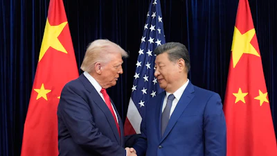 President Donald Trump, left, and Chinese President Xi Jinping, right, shake hands before their meeting at Gimhae International Airport in Busan, South Korea, Thursday, Oct. 30, 2025.
