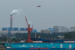 The EHang eVTOL EH126-S takes to the sky over a port in Guangzhou in southern China's Guangdong province on Monday, Nov. 3, 2025.