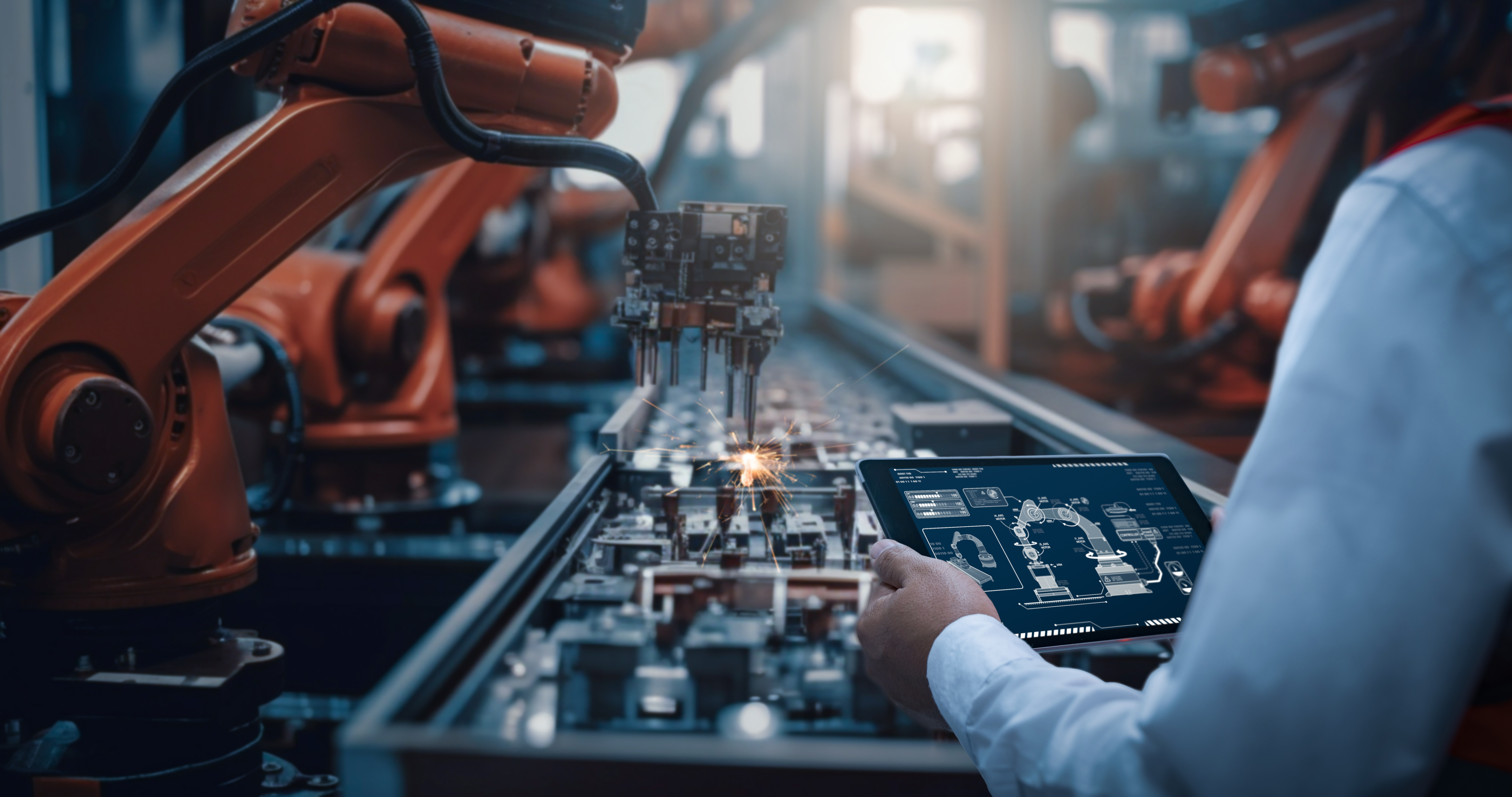 Industrial robotic arms operating on a manufacturing assembly line.