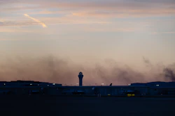 The ATC tower is seen while smoke rises from the crash site of UPS Flight 2976 near Louisville Muhammad Ali International Airport on Wednesday, Nov. 5, 2025, in Louisville, Ky.