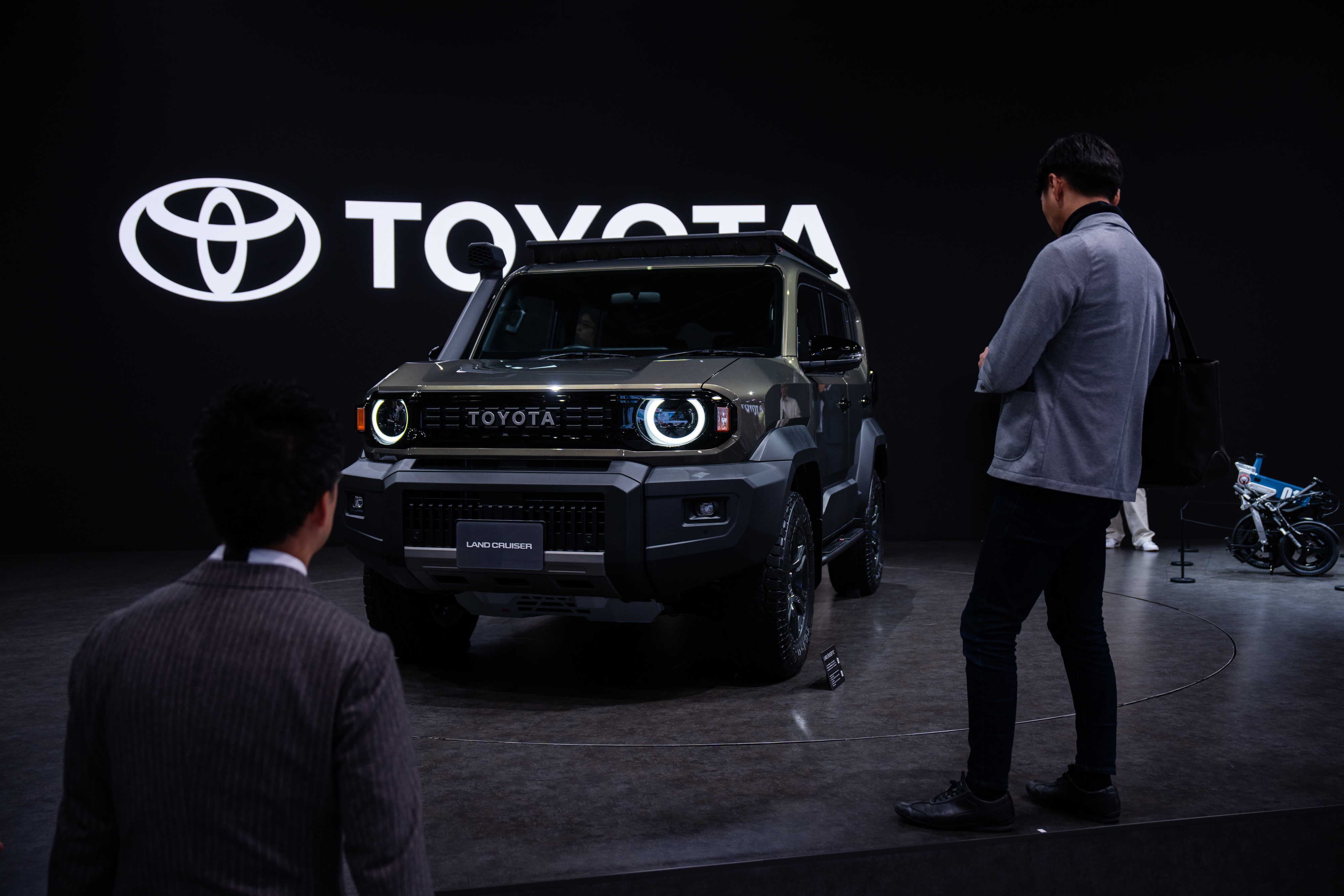 Members of the media and guests look at Toyota's Corolla concept during the press day of the Japan Mobility Show, in Tokyo, Thursday, Oct. 30, 2025.