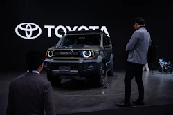 Members of the media and guests look at Toyota's Corolla concept during the press day of the Japan Mobility Show, in Tokyo, Thursday, Oct. 30, 2025.