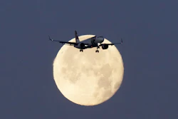 A TAP Air Portugal Airbus A320 is silhouetted against the setting moon while approaching for landing in Lisbon, Portugal, June 23, 2024.