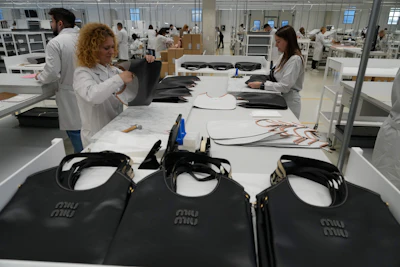 Leather good operators work at the Prada factory in Scandicci, Italy, Friday, Nov. 28, 2025.