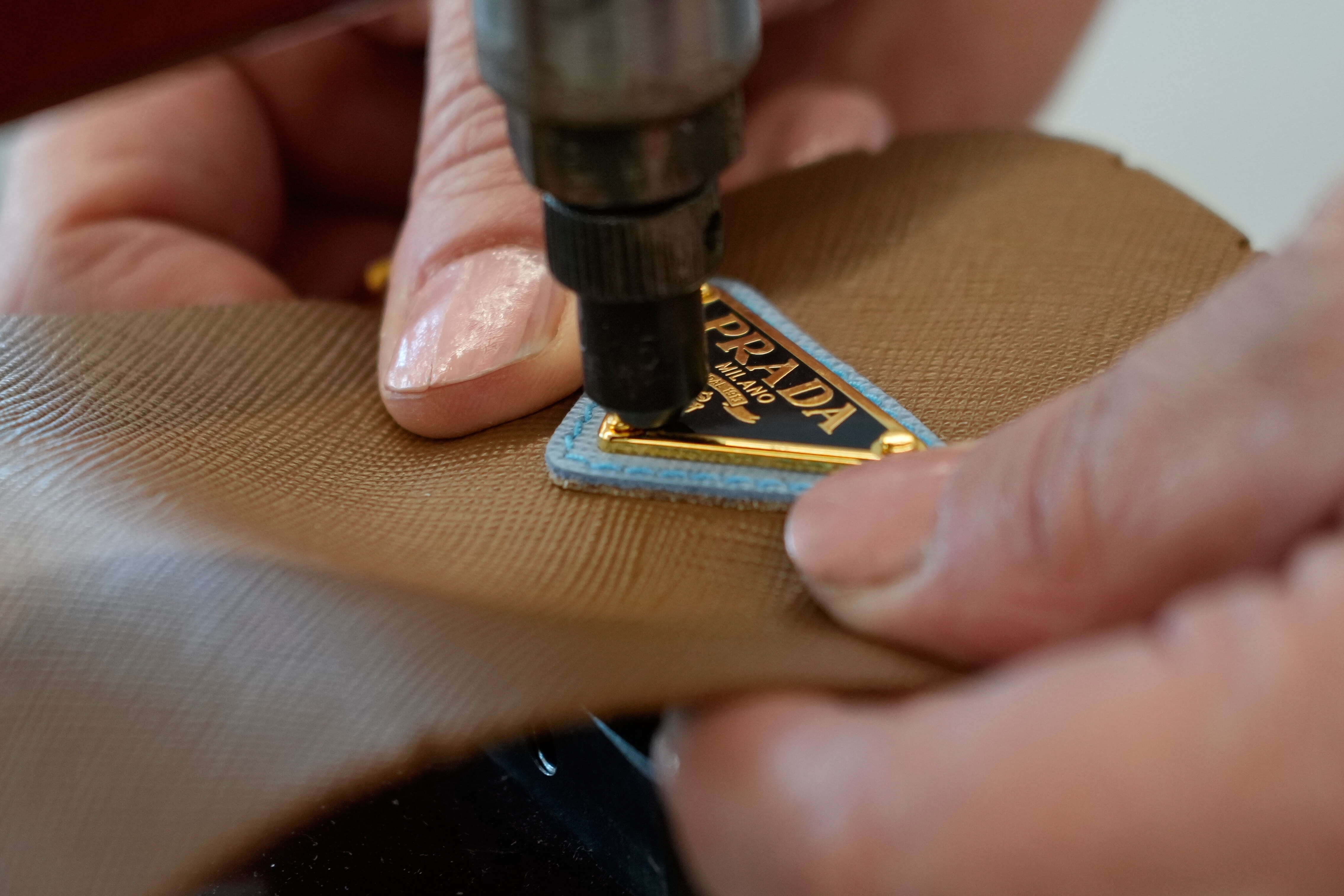 A leather good operator works at the Prada factory in Scandicci, Italy, Friday, Nov. 28, 2025.