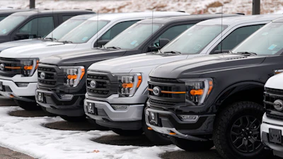 Unsold 2024 F150 pickup trucks sit in a long row at a Ford dealership Sunday, Jan. 21, 2024, in Broomfield, Colo.