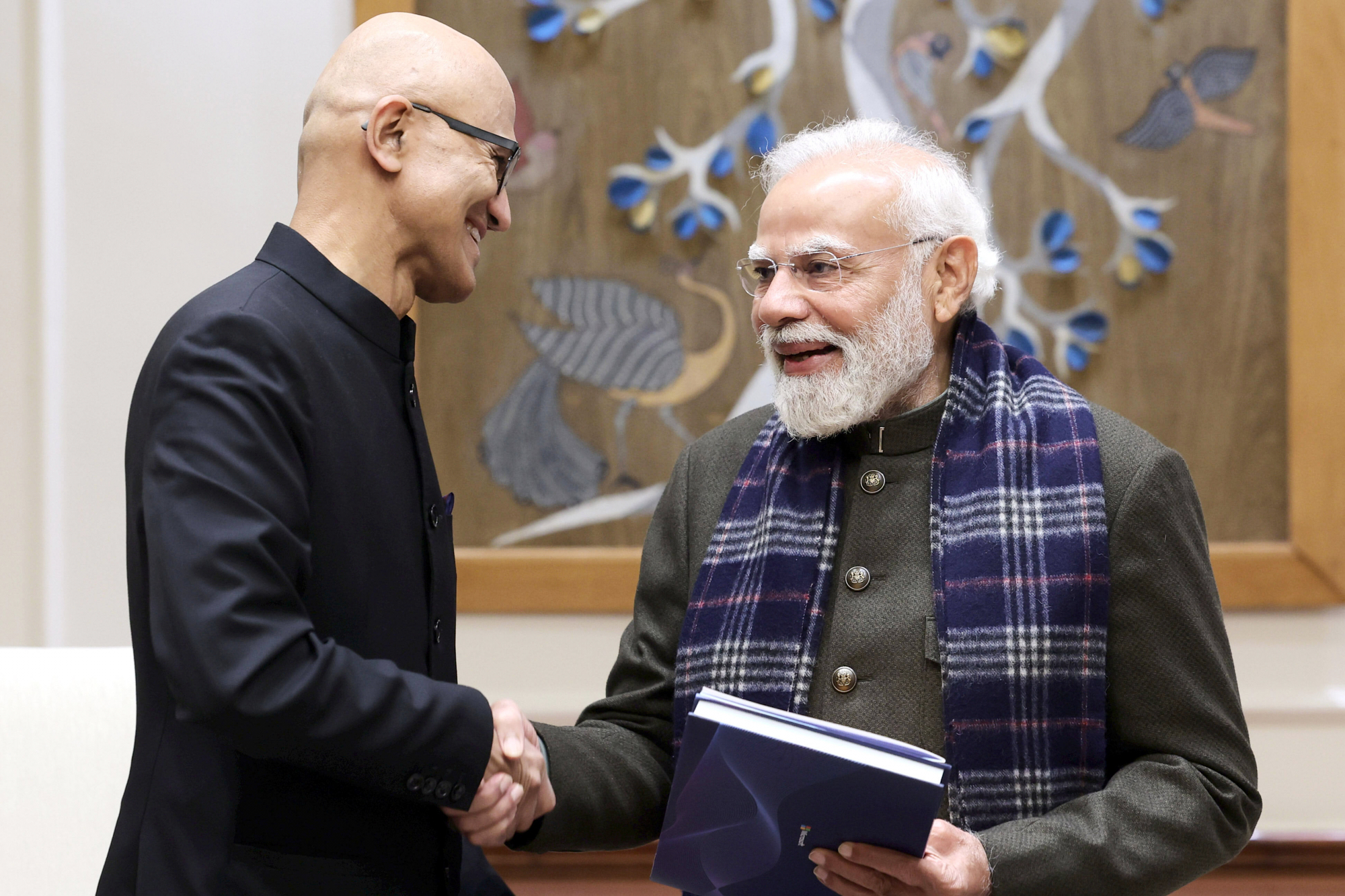 In this handout photo provided by Microsoft, Chief Executive Officer Satya Nadella, left, shakes hands with Indian Prime Minister Narendra Modi during their meeting in New Delhi, India, Tuesday, Dec. 9, 2025.