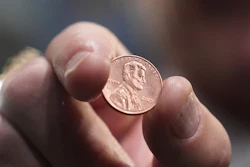 U.S. Treasurer Brandon Beach holds one of the last pennies pressed at the U.S. Mint, in Philadelphia, Nov. 12, 2025.