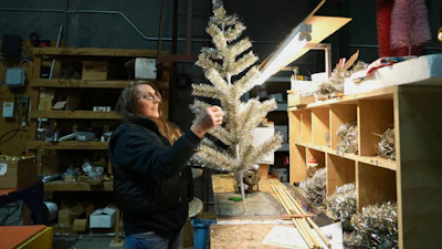 Melissa Webb assembles an artificial Christmas tree at Lee Display's warehouse, in Fairfield, Calif., Tuesday, Dec. 9, 2025.