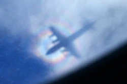 The shadow of a Royal New Zealand Air Force P3 Orion is seen on low level cloud while the aircraft searches for missing Malaysia Airlines Flight MH370 in the southern Indian Ocean, near the coast of Western Australia, March 31, 2014.