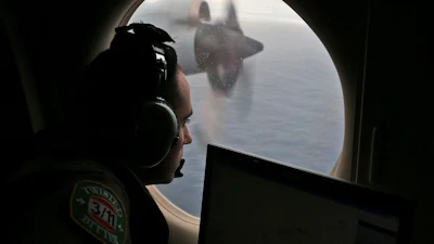 Flight officer Rayan Gharazeddine scans the water in the southern Indian Ocean off Australia from a Royal Australian Air Force AP-3C Orion during a search for the missing Malaysia Airlines Flight MH370 on March 22, 2014.