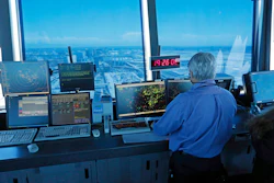 In this Sept. 4, 2013 photo, an air traffic controller works at computer screens and a digital clock showing Coordinated Universal Time (UTC), or Zulu time, is seen in this view looking eastward from the control tower at Los Angeles International Airport (LAX).