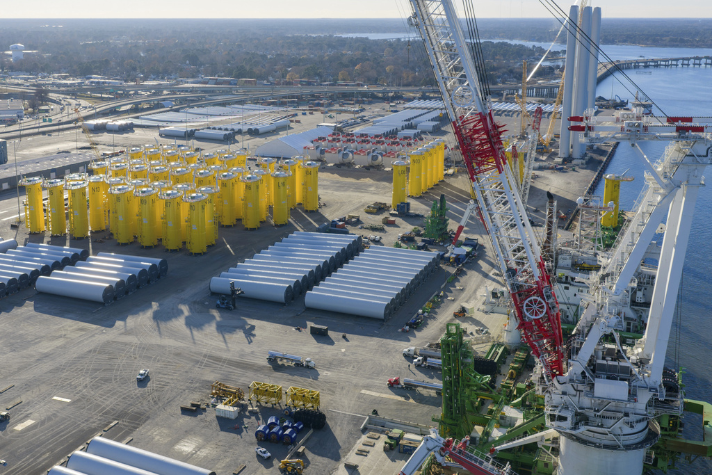 Wind turbine bases, generators and blades sit along with support ships at The Portsmouth Marine terminal that is the staging area for Dominion Energy Virginia, which is developing Coastal Virginia Offshore Wind, Dec. 22, 2025, in Portsmouth, Va.