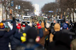 Protesters advance toward federal agents with their hands up near the site of the fatal shooting of 37-year-old Alex Pretti by federal agents in Minneapolis, Jan. 24, 2026.