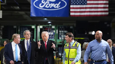 President Donald Trump speaks to, from left Bill Ford, Executive Chairman of Ford, Treasury Secretary Scott Bessent, Jim Farley, CEO of Ford, and Corey Williams, Ford River Rouge Plant Manager, during a tour of the Ford River Rogue complex, Tuesday, Jan. 13, 2026, in Dearborn, Mich.
