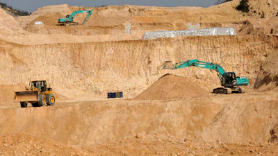 Workers use machinery to dig at a rare earth mine in Ganxian county in central China's Jiangxi province on Dec. 30, 2010.