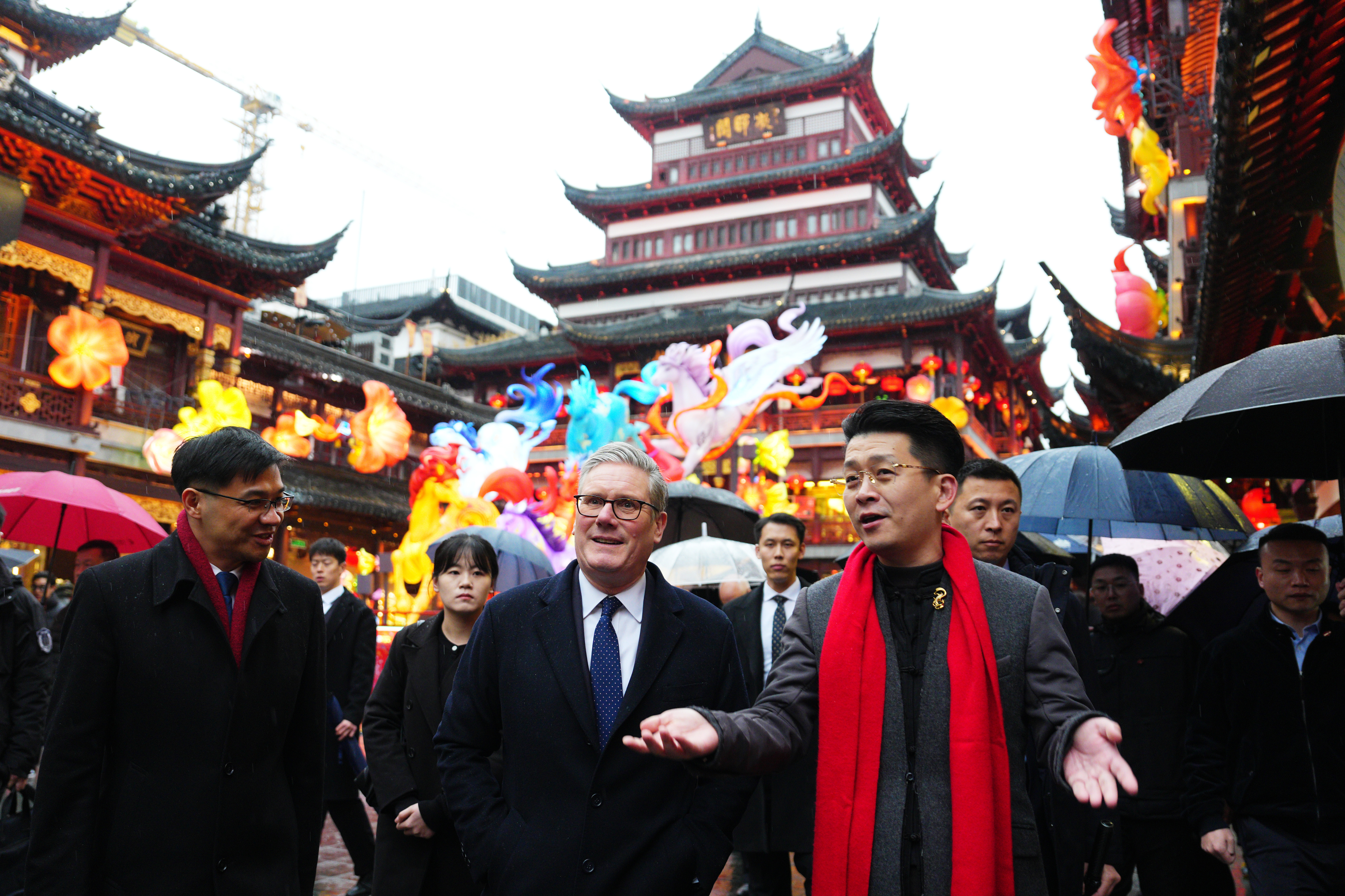 British Prime Minister Keir Starmer, center, is shown around Shanghai's Yuyuan Garden by Vice President of Yuyuan Garden Junjie Hu, Jan. 30, 2026.