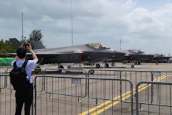 A man takes a picture of a row of F-35 Lightning II fighter jets during the Singapore Air Show on Thursday, Feb. 5, 2026.