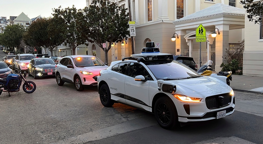 A Waymo driverless taxi stops on a street in San Francisco on Feb. 15, 2023.