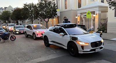 A Waymo driverless taxi stops on a street in San Francisco on Feb. 15, 2023.