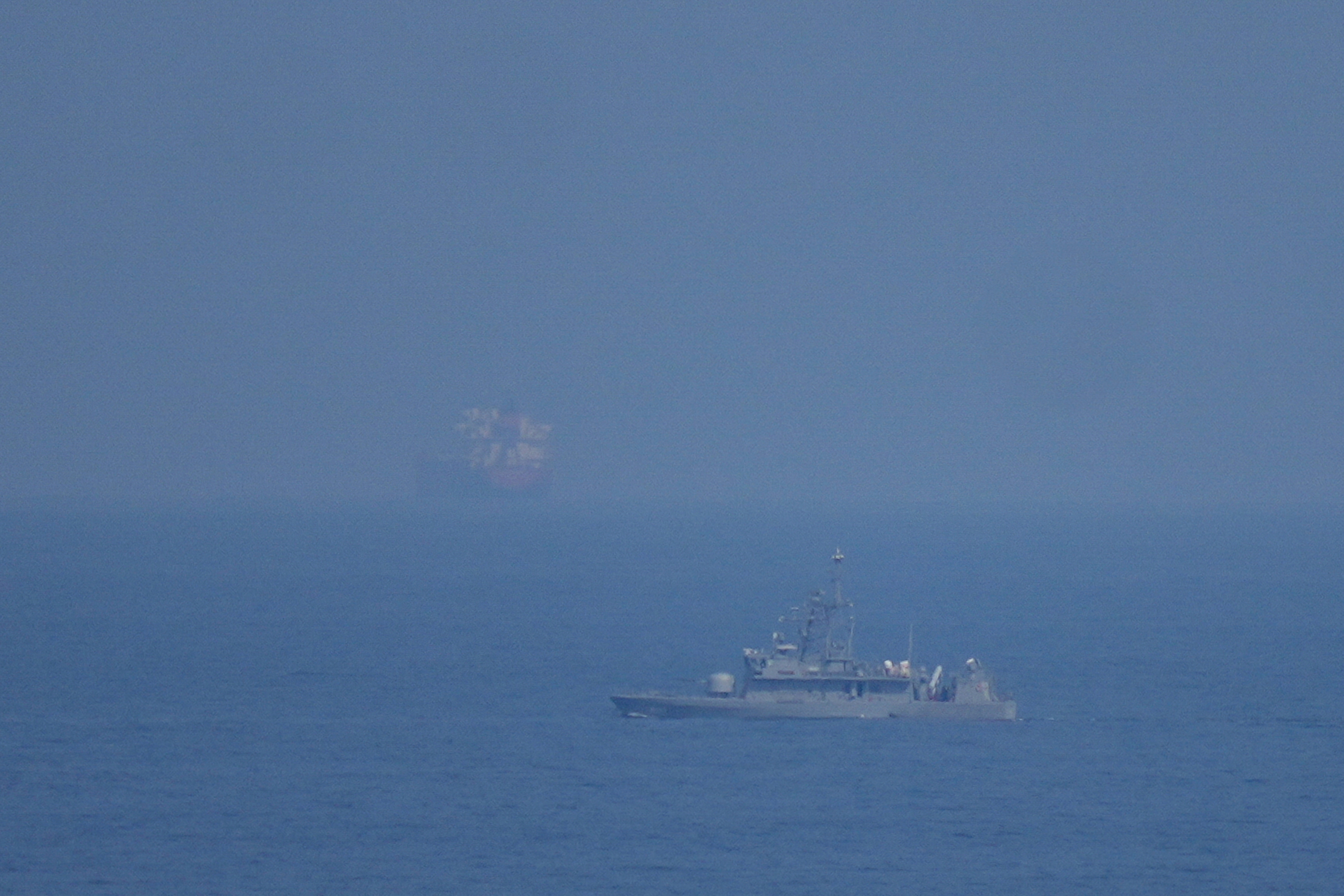 A UAE navy ship patrols the Strait of Hormuz as seen from Mina Al Fajer, United Arab Emirates, March 11, 2026.