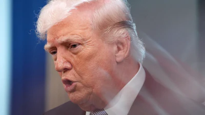 A zoom lens and slow shutter speed technique shows President Donald Trump speaking with reporters in the James Brady Press Briefing Room at the White House, April 6, 2026.