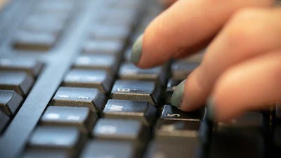 A person types on a computer keyboard in New York, Oct. 8, 2019.