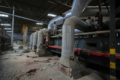 Workers arrive for maintenance work at a closed ceramics factory in Morbi, in the Indian state of Gujarat, Wednesday, April 8, 2026.