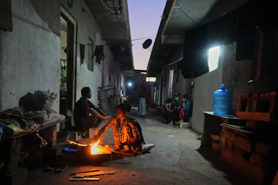 A migrant woman prepares a meal using firewood at a deserted ceramics workers' quarters in Morbi, in the Indian state of Gujarat, Wednesday, April 8, 2026.