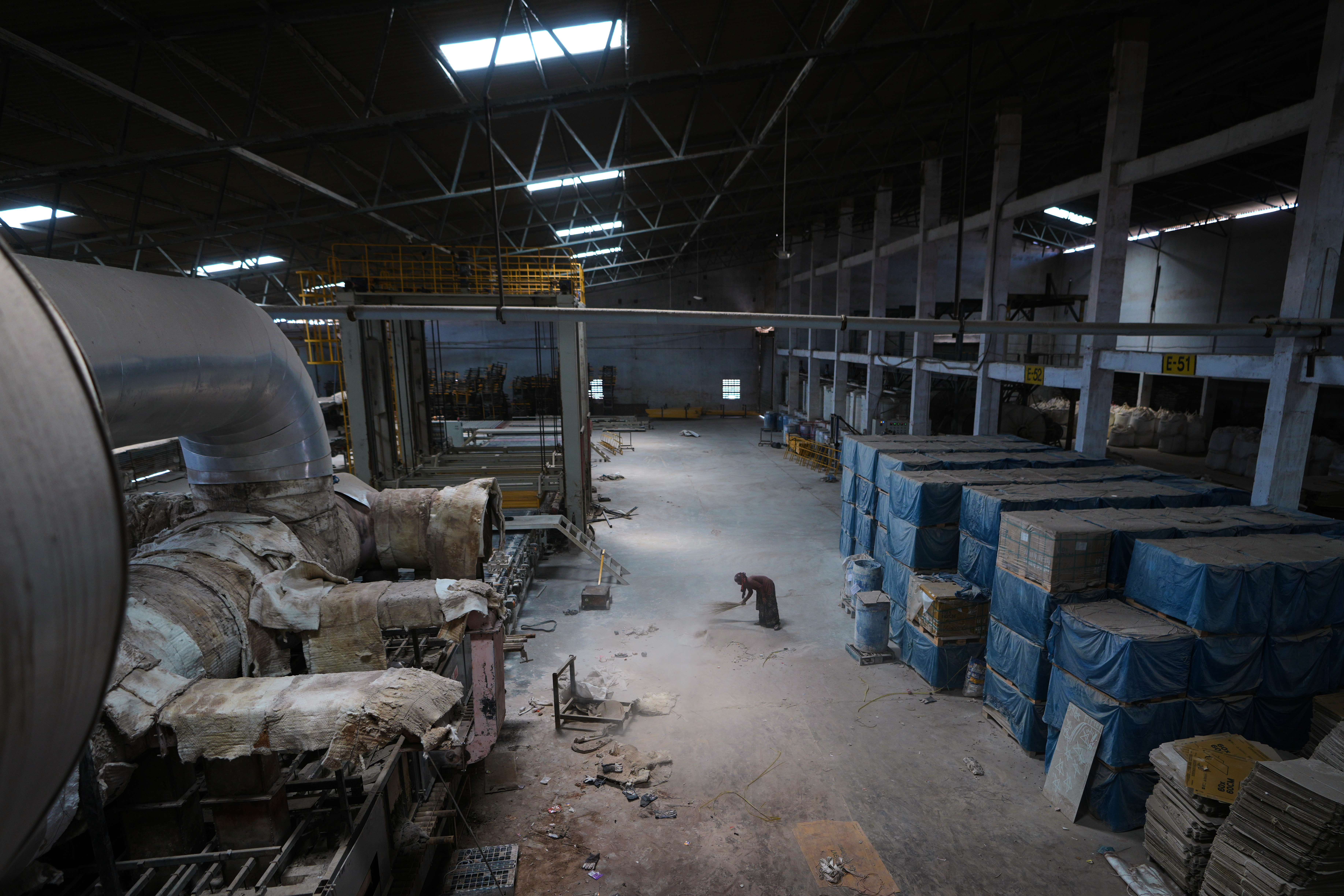 A worker sweeps the floor of a closed ceramics factory in Morbi,in the Indian state of Gujarat, Wednesday, April 8, 2026.